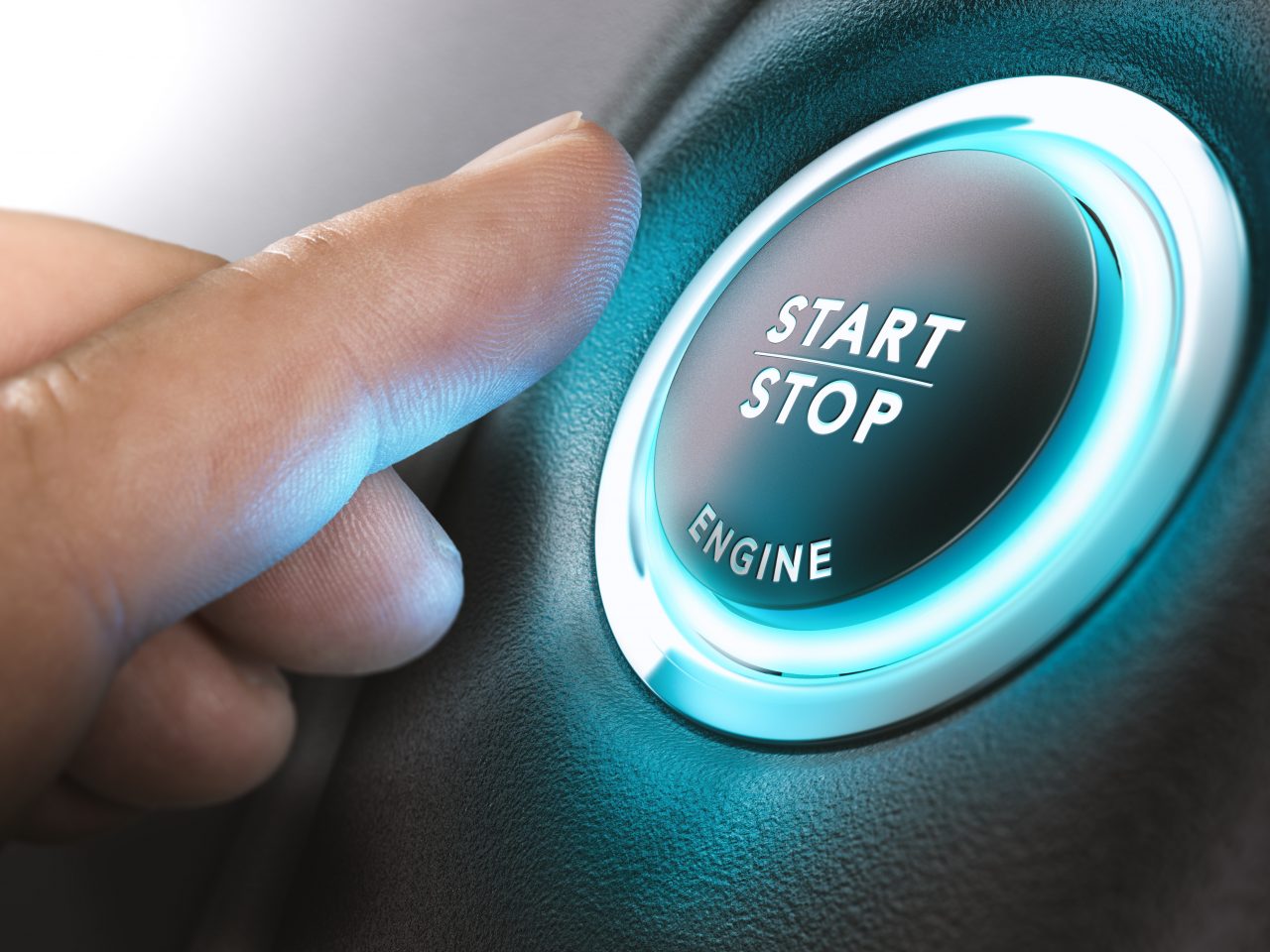 Car stop start system with finger pressing the button, horizontal image
